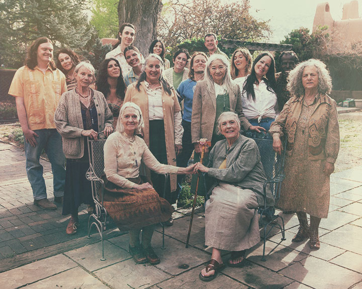 A large group of the Belhor Healing Center community gathered together in a courtyard