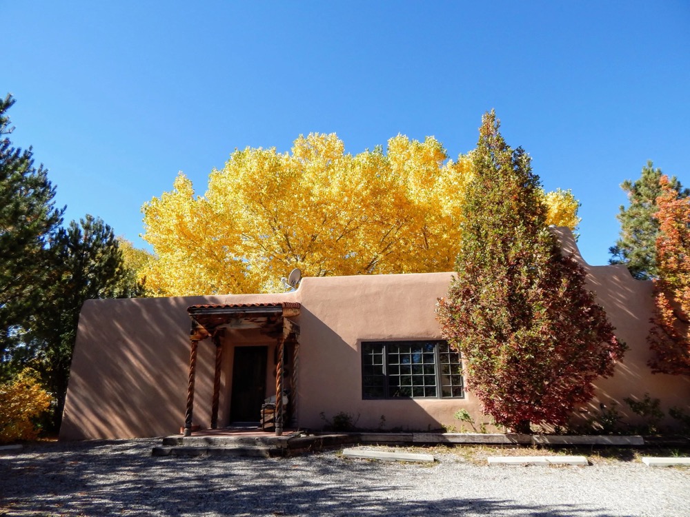 Adobe exterior in brilliant autumn color under a clear blue sky