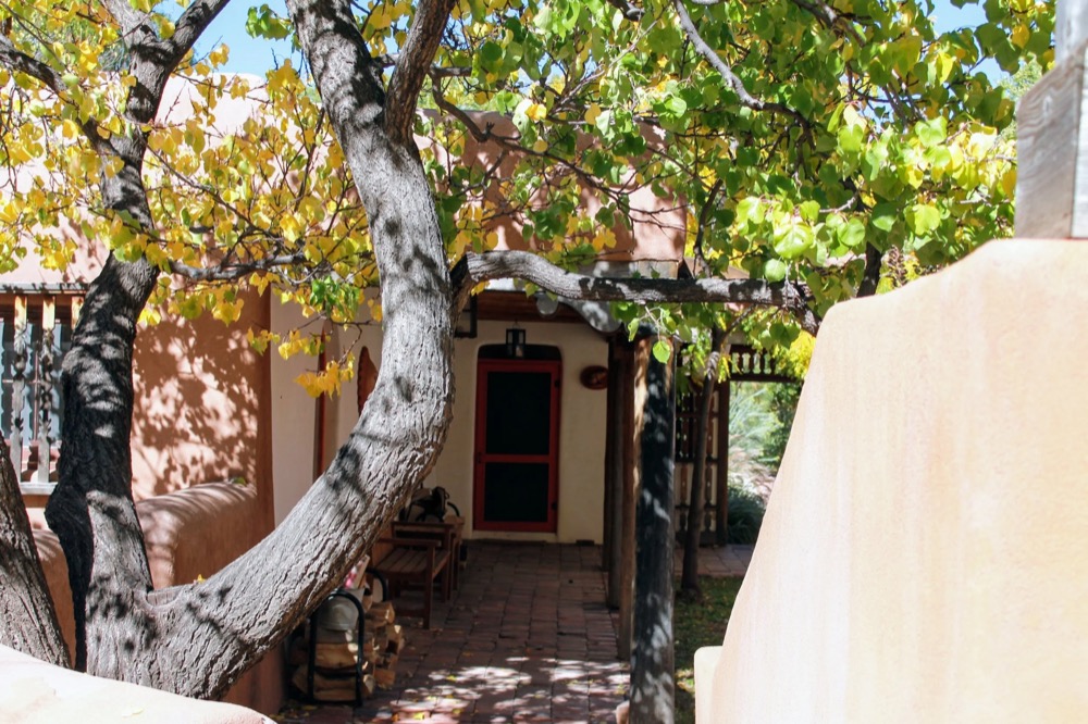 A tree-shaded walkway leading to a guest room door at the Center