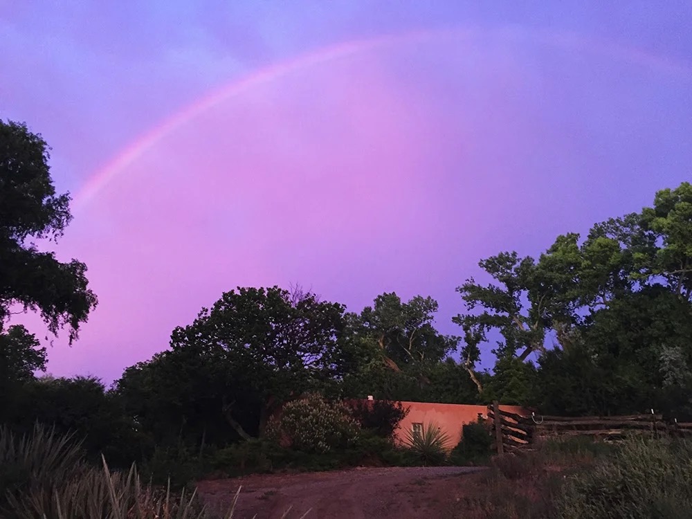 A rainbow over the grounds at dusk